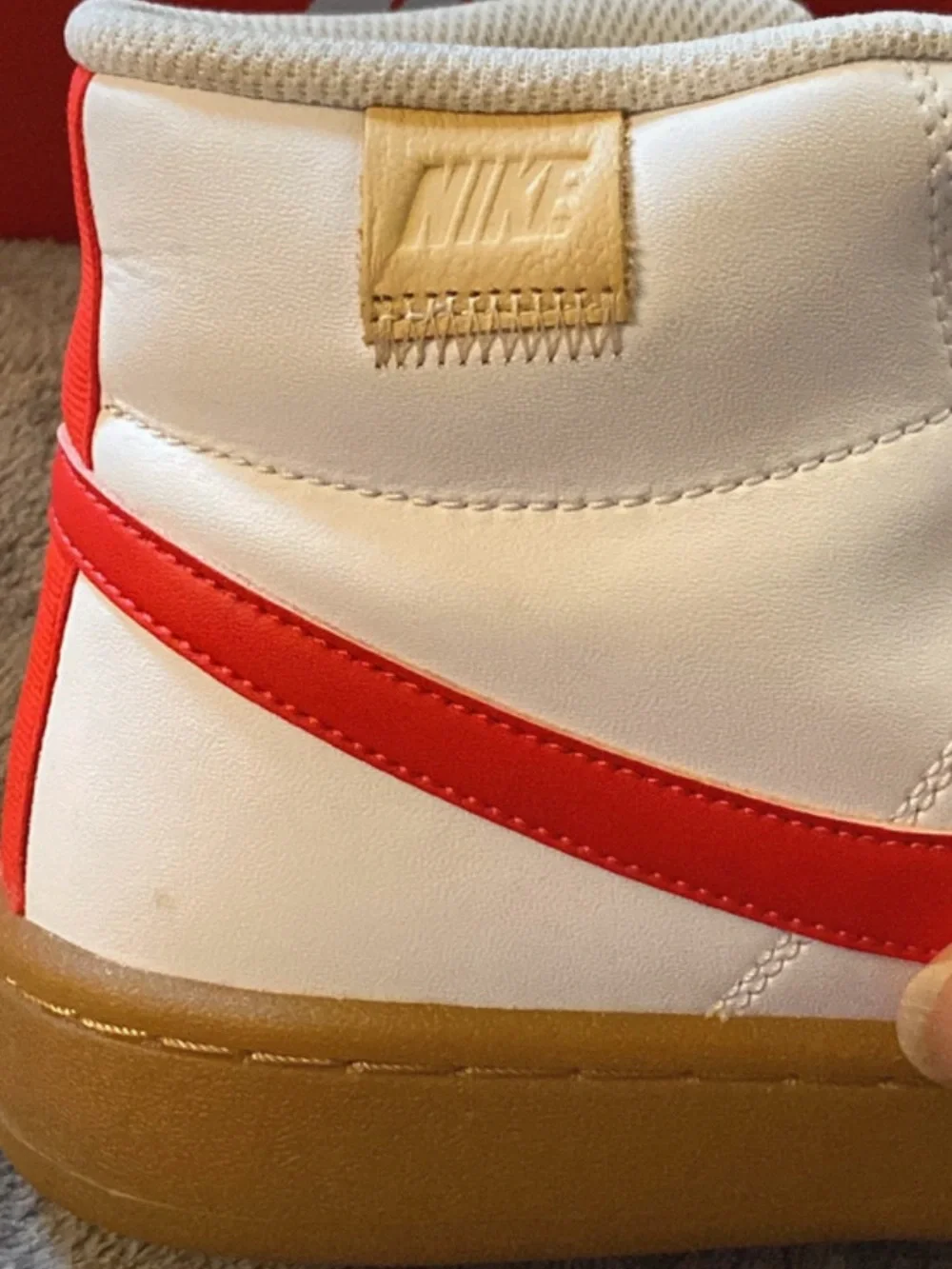 Nike White High-Top Sneakers with Red Swoosh and Gum Sole